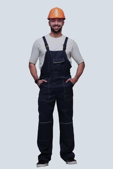 in full growth. confident man in overalls . isolated on white background