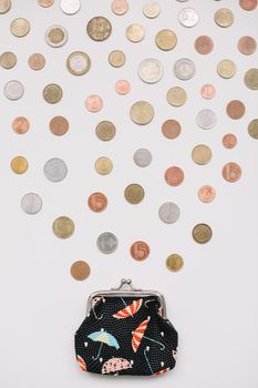 Open purse with different coins isolated on white background top view. Financial crisis, poverty, lack of money