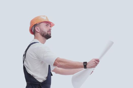 in full growth. competent foreman Builder looking at drawings. isolated on white background