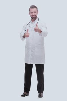 in full growth. smiling medical professional showing thumbs up .isolated on white background