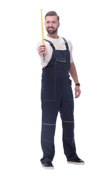 in full growth. a man in overalls with a construction tape measure. isolated on white background