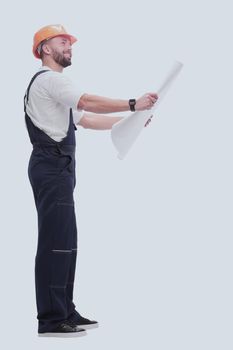 in full growth. competent foreman Builder looking at drawings. isolated on white background