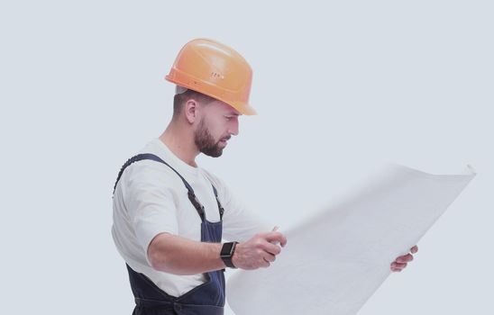 in full growth. competent foreman Builder looking at drawings. isolated on white background