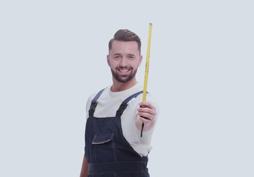 in full growth. a man in overalls with a construction tape measure. isolated on white background