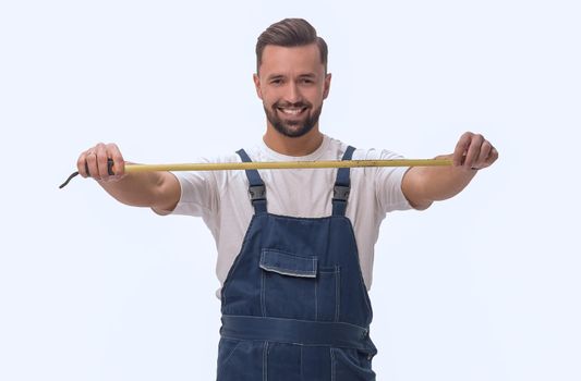 in full growth. smiling man with construction tape measure. isolated on white background