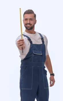 in full growth. a man in overalls with a construction tape measure. isolated on white background