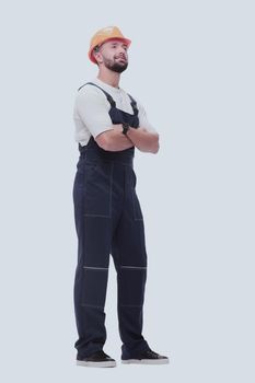 in full growth. smiling man in overalls and a safety helmet . isolated on white background