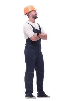 in full growth. smiling man in overalls and a safety helmet . isolated on white background