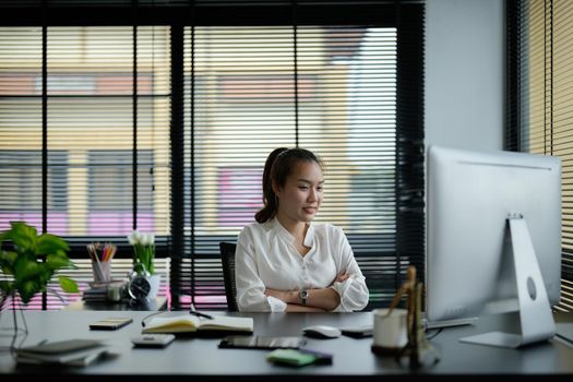 Young asian business woman working on laptop in office.