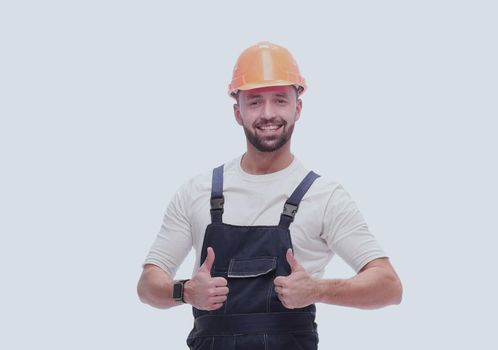 in full growth. smiling man in overalls showing thumbs up . isolated on white background