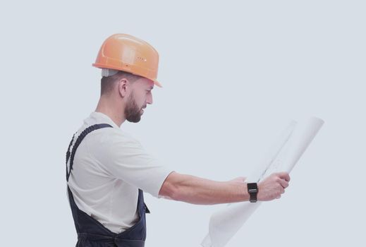 in full growth. competent foreman Builder looking at drawings. isolated on white background