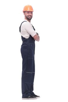 in full growth. smiling man in overalls and a safety helmet . isolated on white background