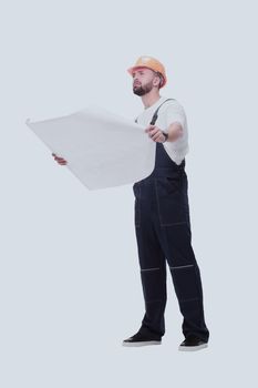 in full growth. competent foreman Builder looking at drawings. isolated on white background