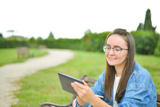 young beautiful student girl is learning outdoor. High quality photo