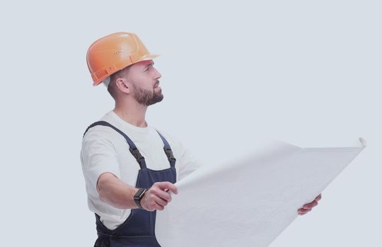 in full growth. competent foreman Builder looking at drawings. isolated on white background