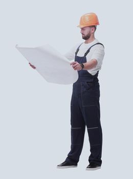 in full growth. competent foreman Builder looking at drawings. isolated on white background