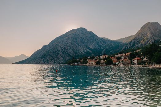 Sunset, beautiful landscape with silhouettes of trees. Travel concept. Montenegro, Kotor Bay. Sunset at Kotor Bay Montenegro. View of the sunset in Boko-Kotor Bay in Montenegro. Silhouettes of mountains. High quality photo