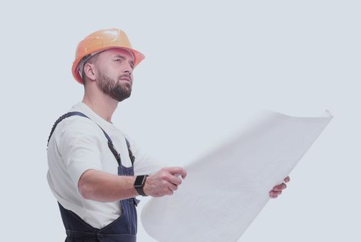 in full growth. competent foreman Builder looking at drawings. isolated on white background