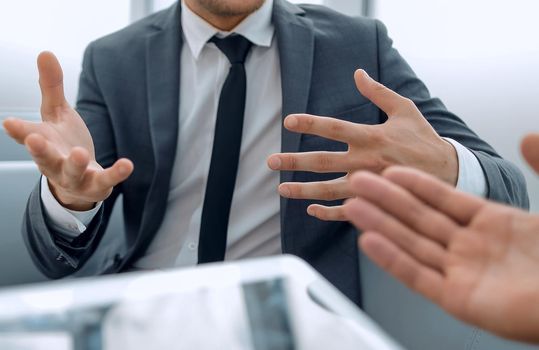 man having tablet in hands,having conference, conversation with her partners, one man on blurred background