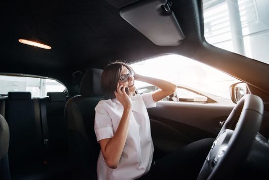 Businesswoman talking on the phone in the car.