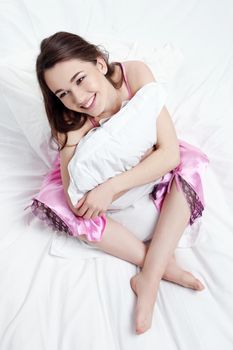 Young beautiful woman sleeping in her bed and relaxing in the morning.