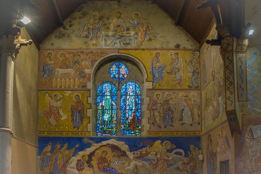 LE MANS, FRANCE - SEPTEMBER 17, 2017: Church St-Lazare in Le mans France with painted frescoes inside of Nikolay Greshniy and catholic stained-glass window