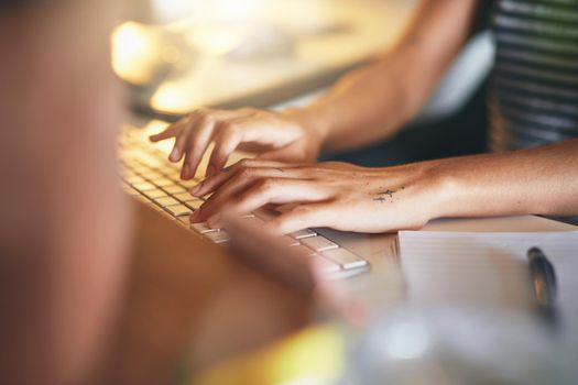 Shot of an attractive young african woman sitting alone and using her computer to work from home stock photo