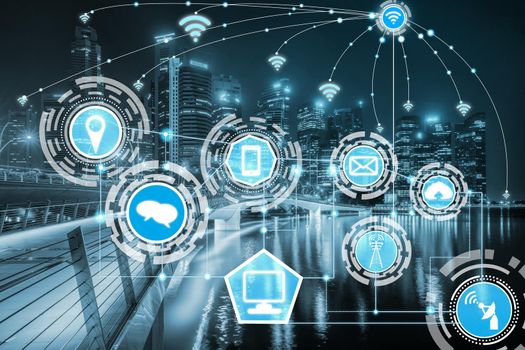 Smart city wireless communication network with graphic showing concept of internet of things ( IOT ) and information communication technology ( ICT ) against modern city buildings in the background.