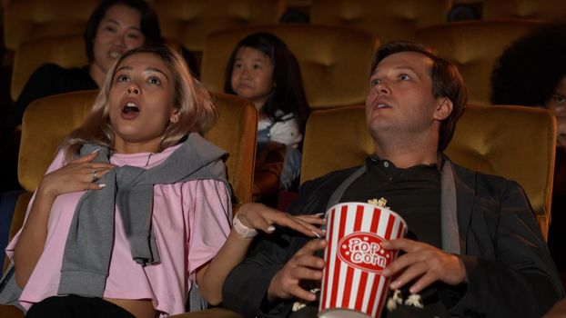 People audience watching movie in the movie theater cinema. Group recreation activity and entertainment concept.