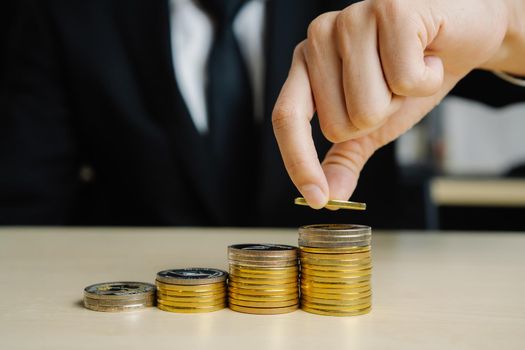Businessman working with coin money currency. Concept of investment growth and money saving.