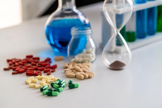 Colorful medicine pills and tablets in pharmaceutical lab. Concept of medical technology research and development for future cure of illness.