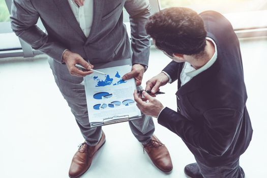 Businessman is in meeting discussion with another businessman partner in modern workplace office. People corporate business team concept.