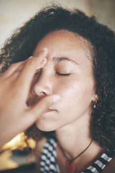 Shot of an attractive young african woman sitting alone and feeling stressed while using her computer to work from home stock photo