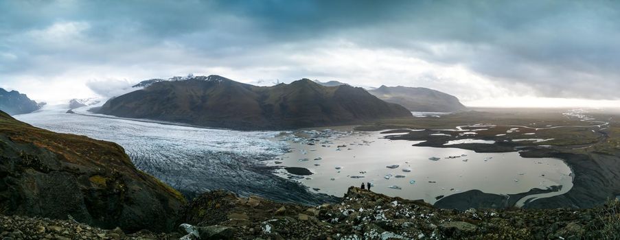 Spectacular viewpoint to massive glacier with unrecognizable tourists