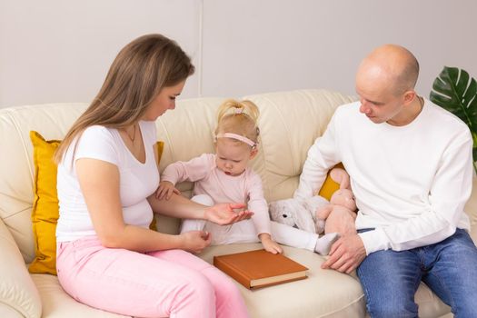 Cochlear implant on the child girl head and playing with mother and father. Hearing aid and deafness and innovative health technology