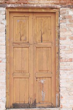 Old wooden door in concrete wall, .