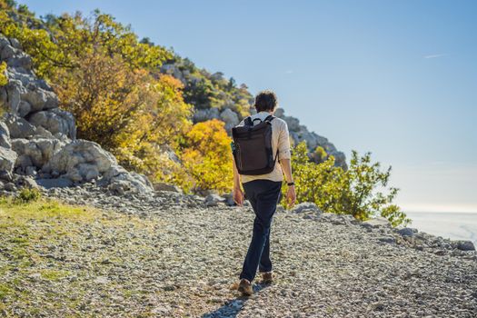 Man on the background of Panoramic view of the city of Budva, Montenegro. Beautiful view from the mountains to the Adriatic Sea.