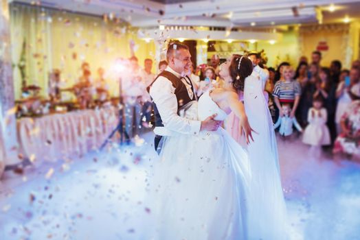 Happy bride and groom and their first dance, wedding in the elegant restaurant with a wonderful light and atmosphere