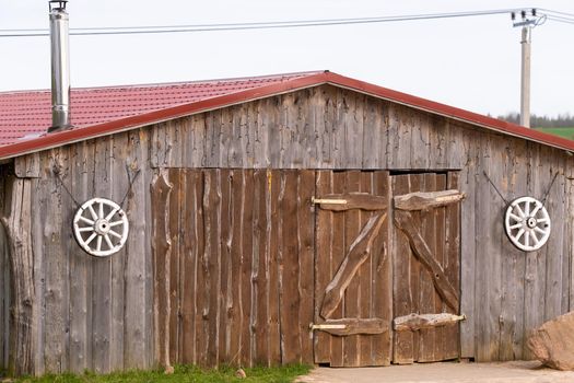 An old barn on the ranch. Large wooden gates and dried wood..