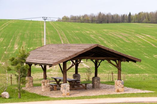 Wooden gazebo standing on the territory near the estate.