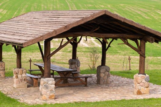 Wooden gazebo standing on the territory near the estate.