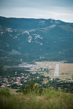 Panoramic view of Grobnik amateur runway and circuit with mountains in a background. Picture taken from Grobnik Castle. Next to runway is Podhum village.