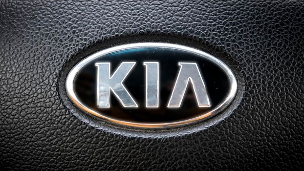 Croatia -7.04.2021 - Kia Car Sign on a steering wheel from Ceed 2013. Leather black background.