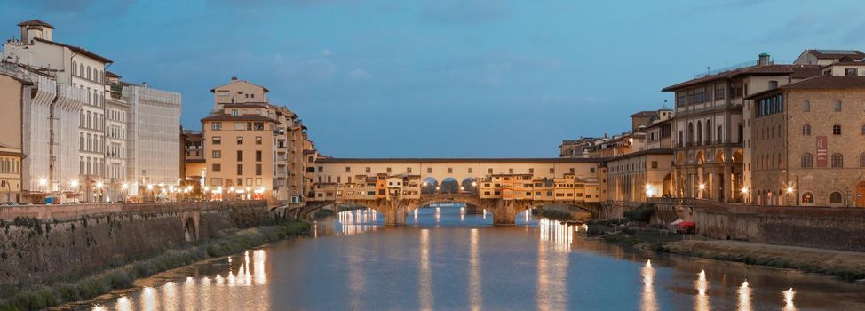 Florence, Italy - circa July 2021. Sunset light on Ponte Vecchio - Old Bridge.