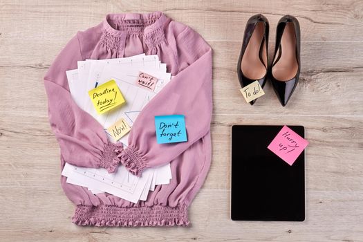 Work woman accessories and black shoes on the desk. Top view flat lay.