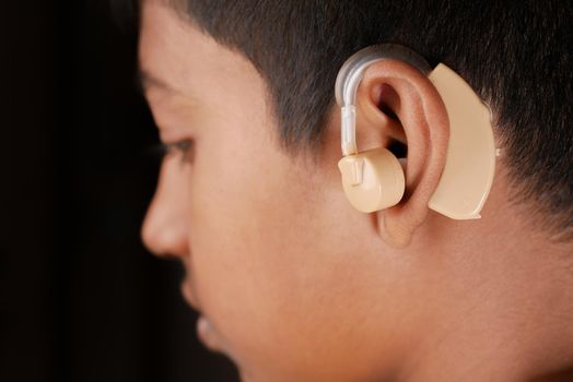 Hearing aid concept, teenage boy with hearing problems.,