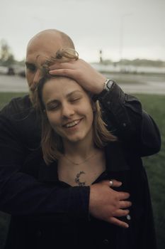 a guy plays with the hair of his beloved after the rain