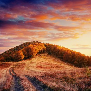 Autumn road in the mountains. Fantastic cumulus clouds, dramatic skies. Dramatic scene. Sunset. Europe