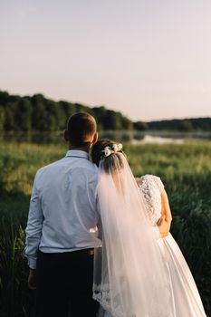 Bride and groom, newlyweds, honeymoon on the beach sunset sun at forest