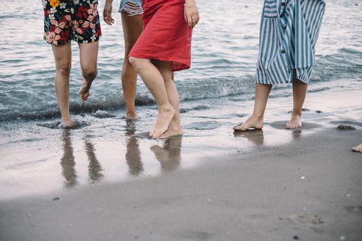 Woman at beach stay in a sea water legs only